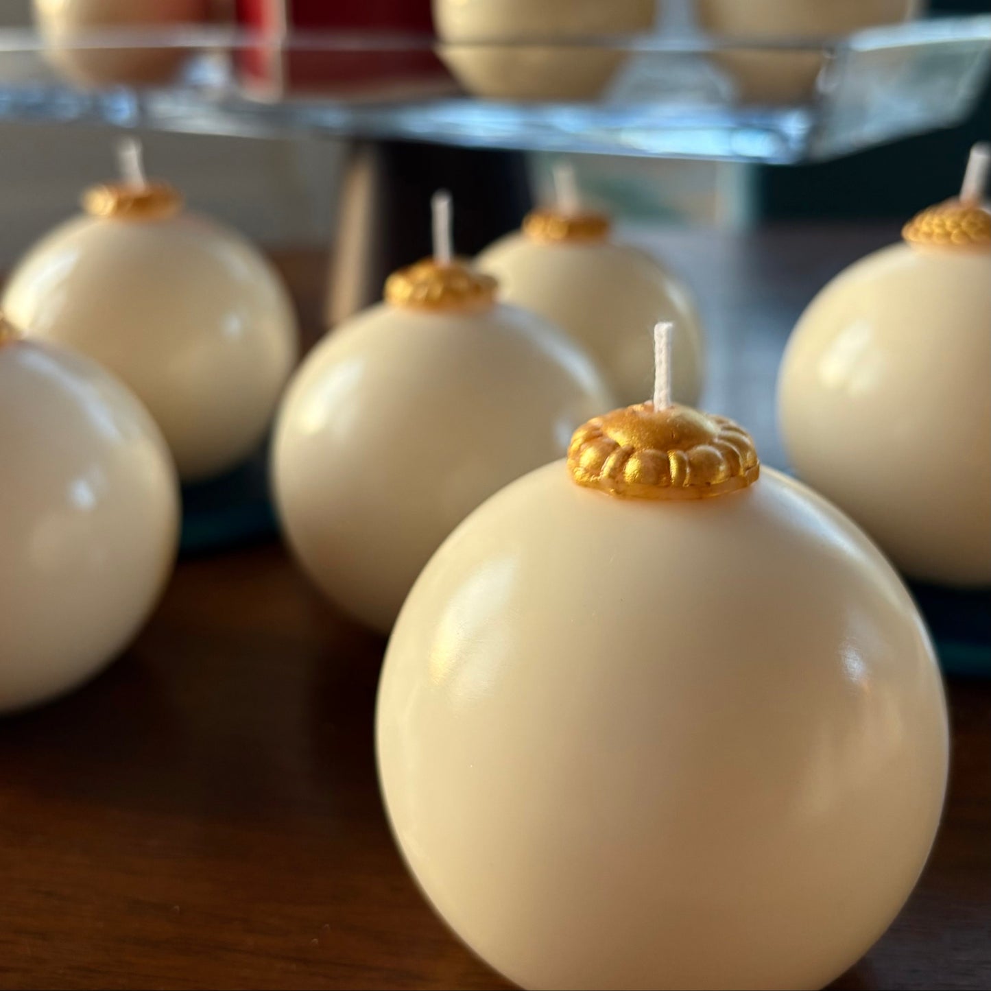 White spherical candles with gold tops